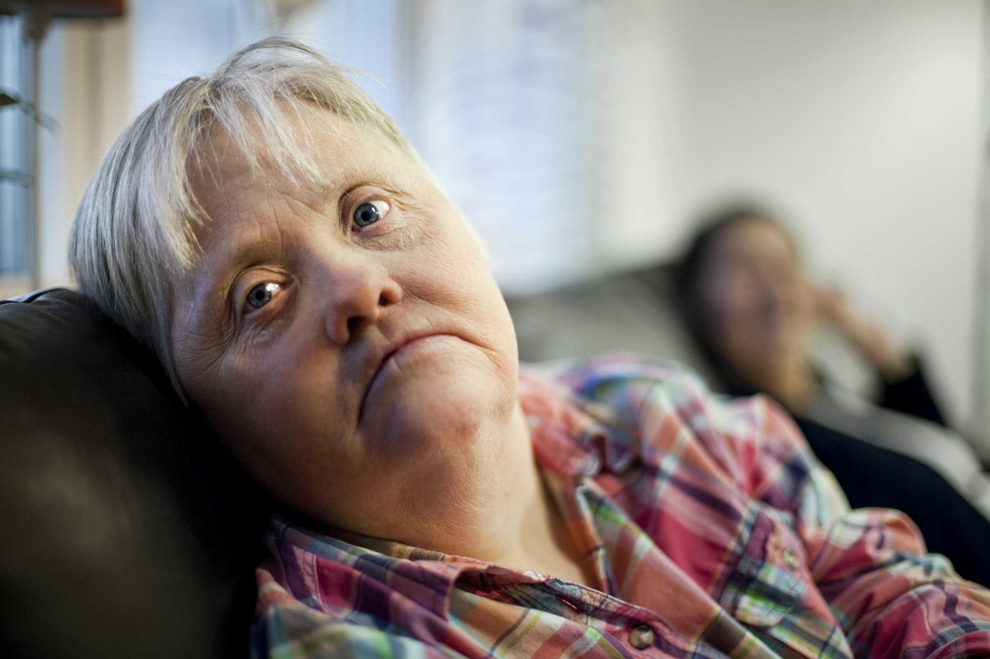 Portrait of mature woman with down syndrome relaxing at nursing home