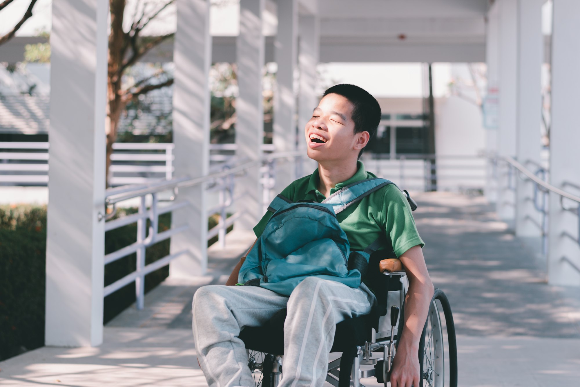 special child on wheelchair is smiling face as happiness on ramp for disabled people