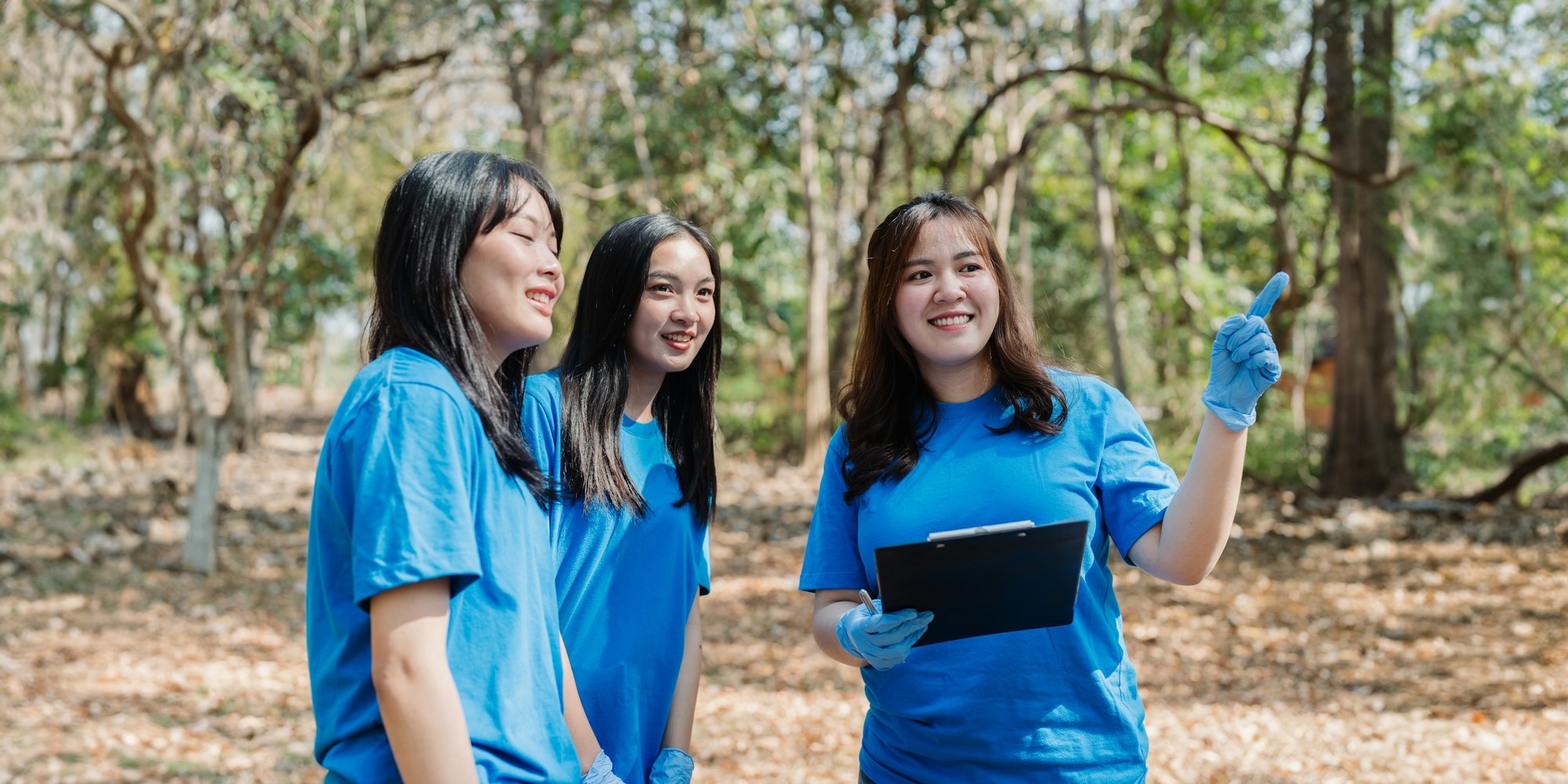 Volunteer team in nature for community service, teamwork and planning with leadership