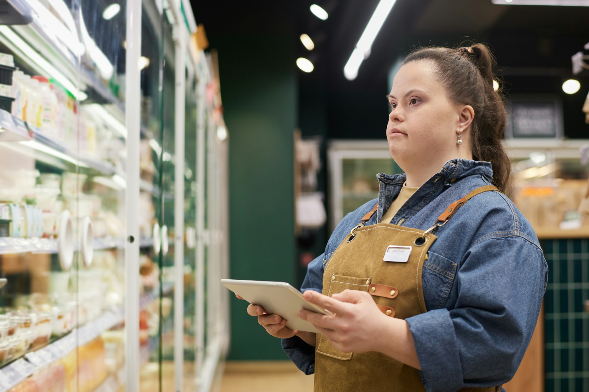 Woman with Disability Working in Supermarket Wearing Apron