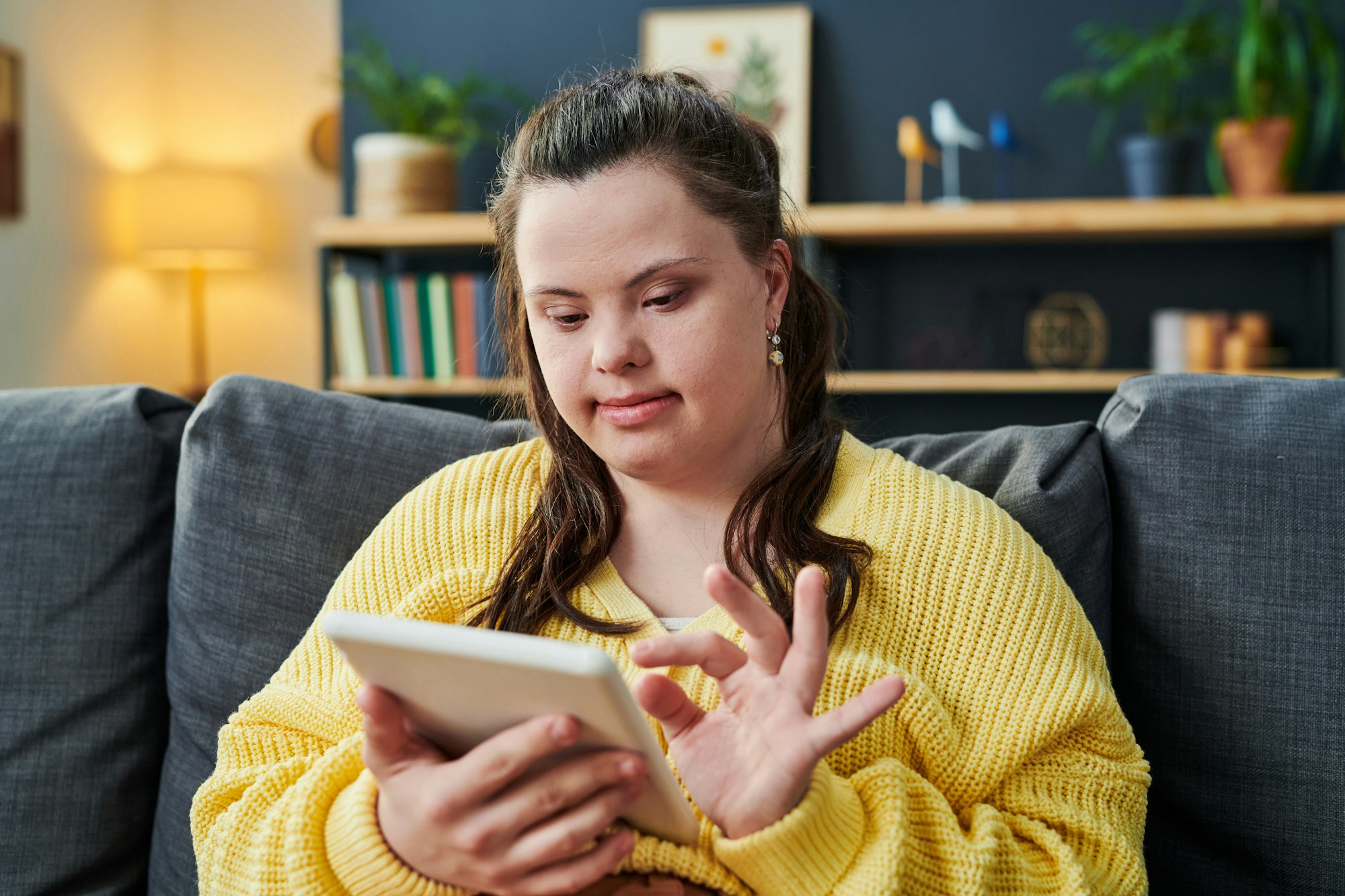 Young Woman With Disability Using Tablet